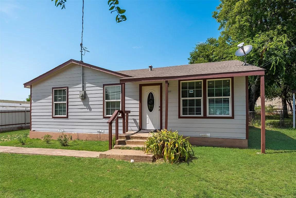 Completed exterior renovation with new siding, trim, and covered porch