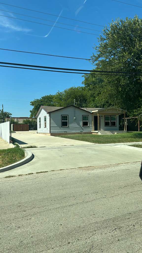 Street view of a completed home renovation with new driveway