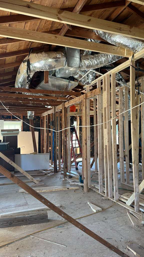 Interior framing and HVAC ductwork during a full home remodel