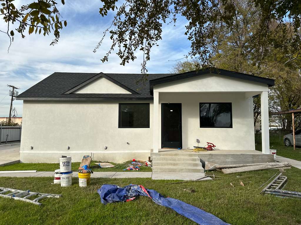 Finished stucco exterior remodel with new roof and front porch